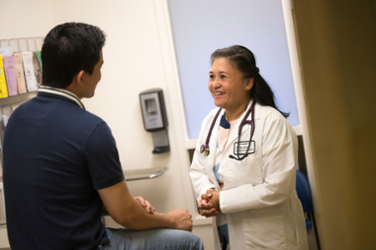 doctor talking with student during appointment